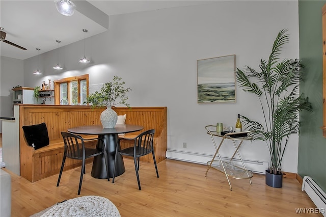9466 Ridge Rd, Hartland, NY 14105 - dining area featuring a baseboard heating unit, ceiling fan, and light wood-style flooring