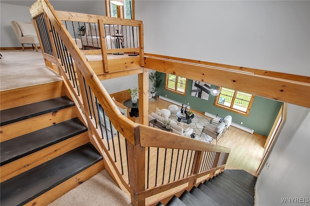 9466 Ridge Rd, Hartland, NY 14105 - stairs with baseboards, wood finished floors, and a baseboard heating unit