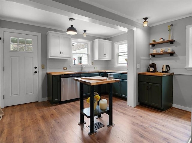 kitchen with dishwasher, white cabinets, butcher block countertops, light wood-style flooring, and crown molding