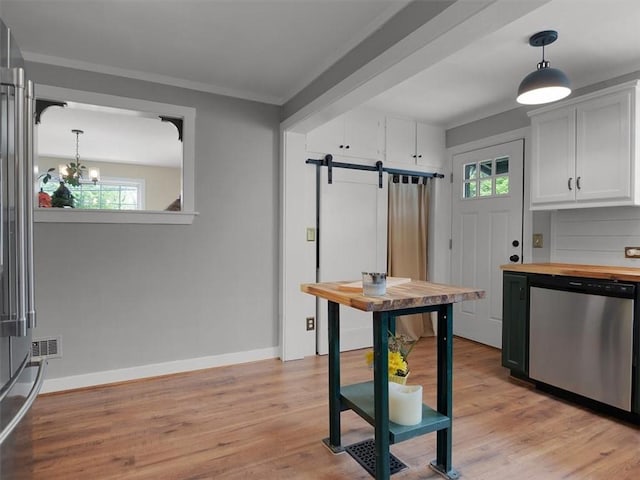 kitchen with dishwasher, a barn door, wooden counters, a chandelier, and light wood finished floors
