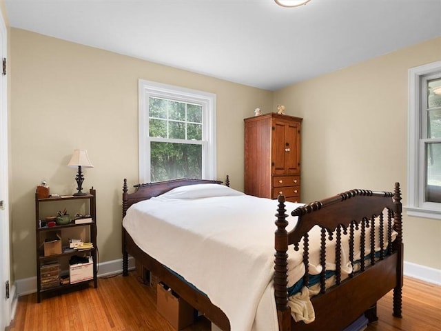 bedroom featuring light wood-style floors and baseboards