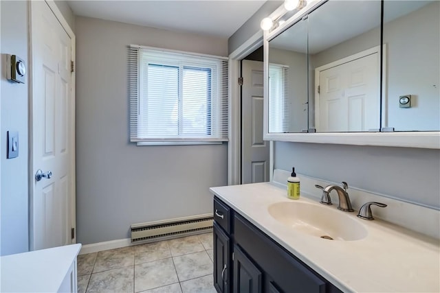 bathroom featuring a baseboard heating unit, vanity, tile patterned flooring, and baseboards