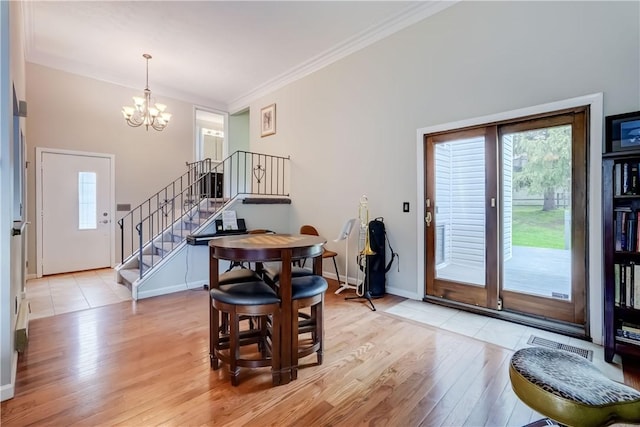 dining room featuring stairs, light wood-style flooring, a chandelier, baseboards, and crown molding
