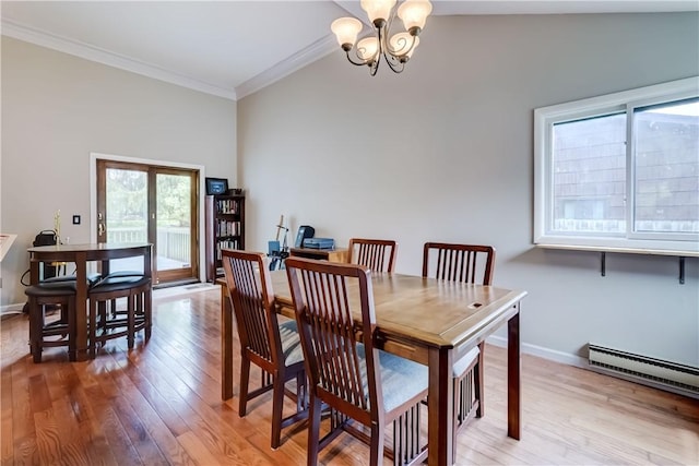 dining area with ornamental molding, a chandelier, light wood-style flooring, baseboard heating, and baseboards