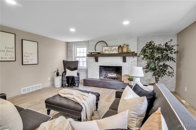 47 Sandelwood Dr, Amherst, NY 14068 - living area featuring wood finished floors, baseboards, a fireplace, recessed lighting, and brick wall