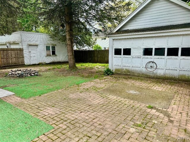 view of side of property featuring an outbuilding and fence