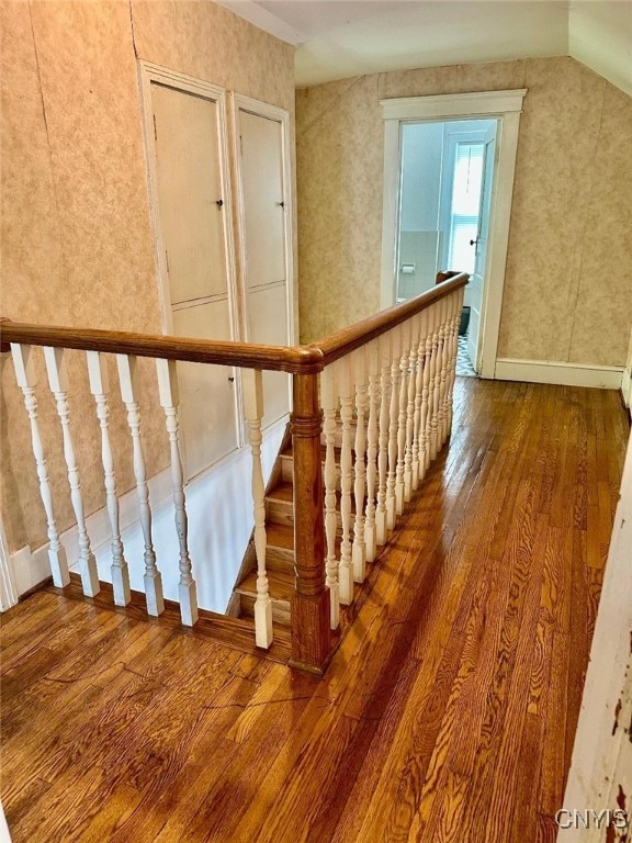 stairway with hardwood / wood-style flooring and baseboards