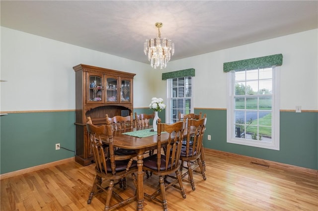 dining space featuring a chandelier and light wood finished floors