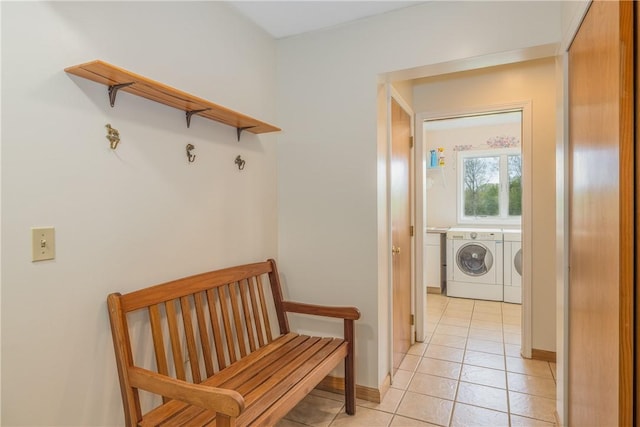 mudroom featuring washer and clothes dryer and light tile patterned floors