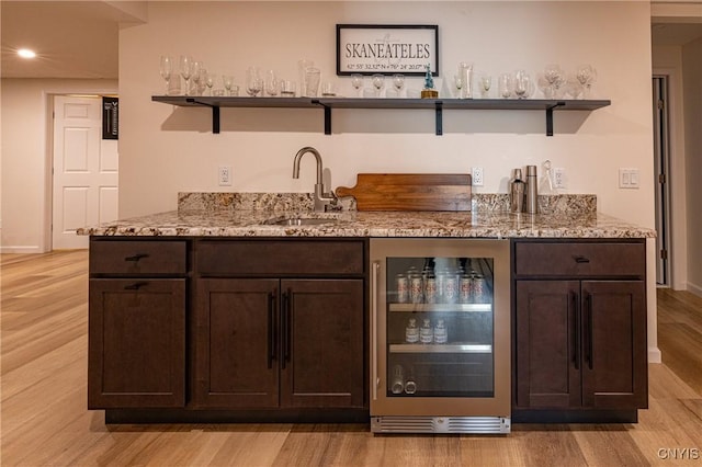 4490 Lauder Ln, Skaneateles, NY 13152 - indoor wet bar with beverage cooler, light wood-style floors, recessed lighting, and baseboards