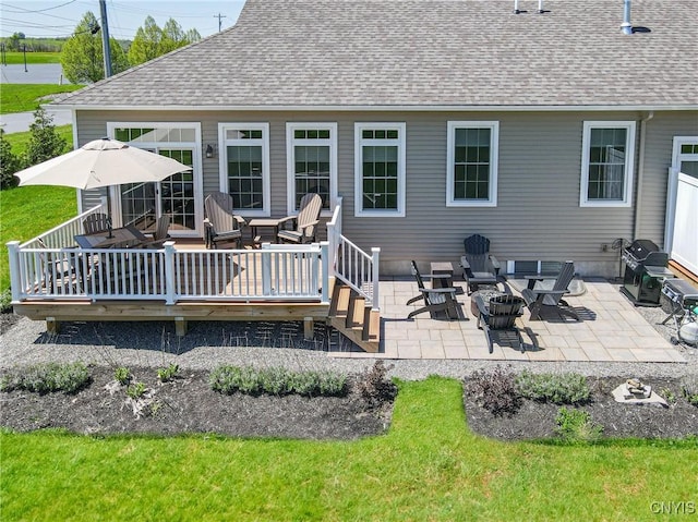 4490 Lauder Ln, Skaneateles, NY 13152 - back of house featuring a wooden deck, a shingled roof, a fire pit, and a patio area