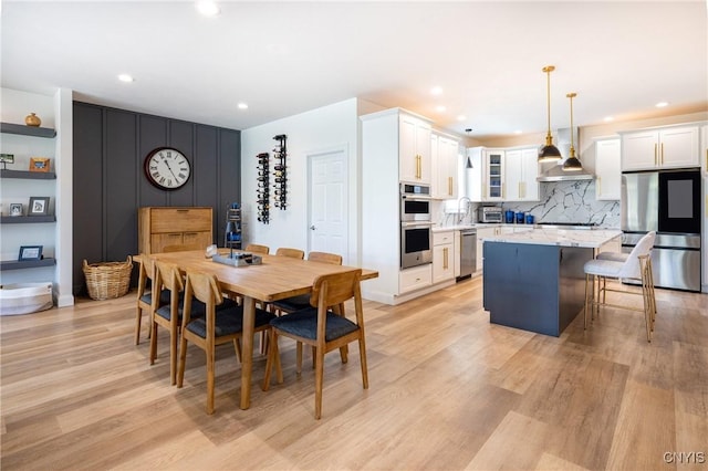 4490 Lauder Ln, Skaneateles, NY 13152 - dining area with light wood-style flooring and recessed lighting
