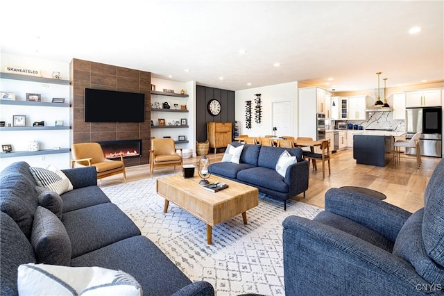 4490 Lauder Ln, Skaneateles, NY 13152 - living room featuring recessed lighting, light wood-style flooring, and a fireplace