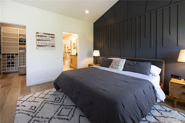 4490 Lauder Ln, Skaneateles, NY 13152 - bedroom featuring a spacious closet, light wood finished floors, lofted ceiling, baseboards, and a closet