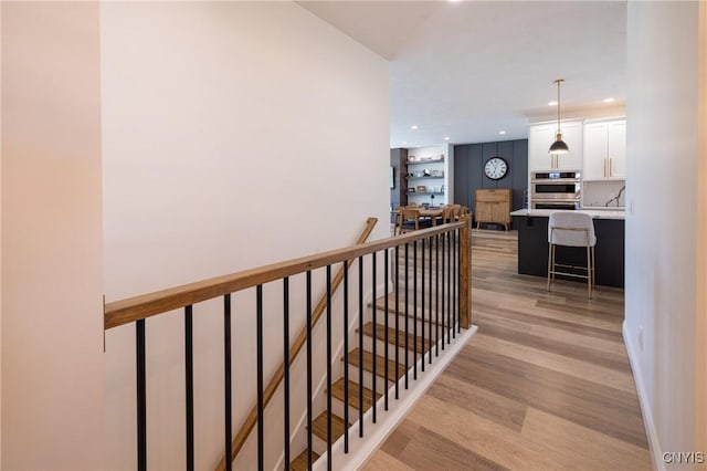 4490 Lauder Ln, Skaneateles, NY 13152 - hall with an upstairs landing, light wood-type flooring, and recessed lighting