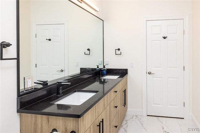 4490 Lauder Ln, Skaneateles, NY 13152 - bathroom featuring marble look tiles, double vanity, and baseboards