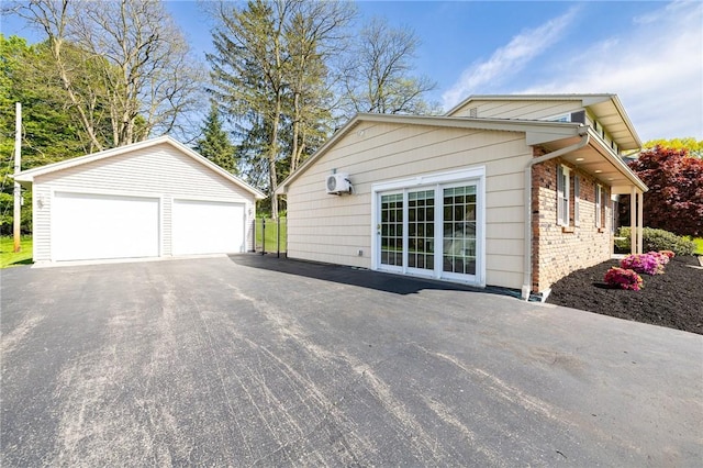 view of side of home with an outdoor structure and a detached garage