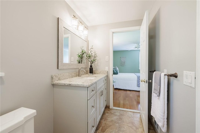 bathroom featuring vanity, toilet, ensuite bathroom, and a ceiling fan