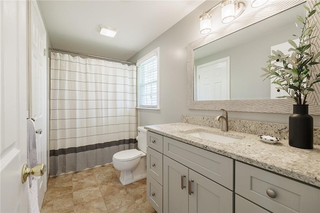 bathroom featuring toilet, vanity, and curtained shower