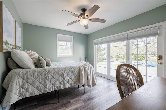 bedroom with access to exterior, wood finished floors, and ceiling fan