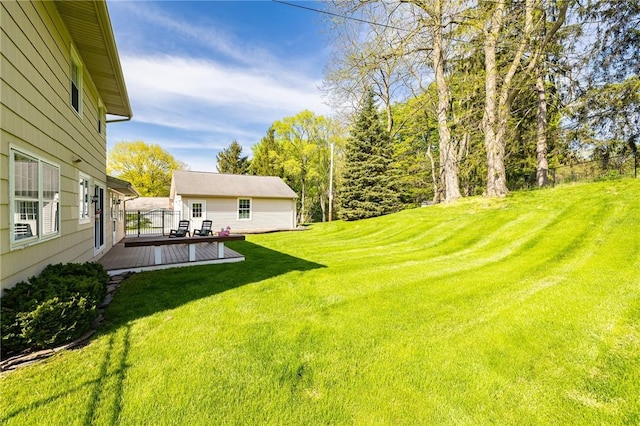 view of green lawn with a deck