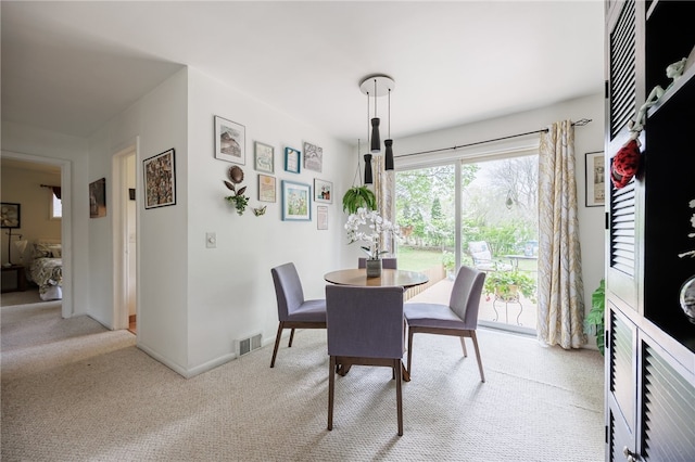 dining area with carpet floors and baseboards