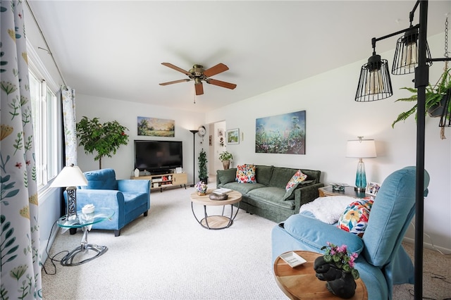 carpeted living area featuring ceiling fan