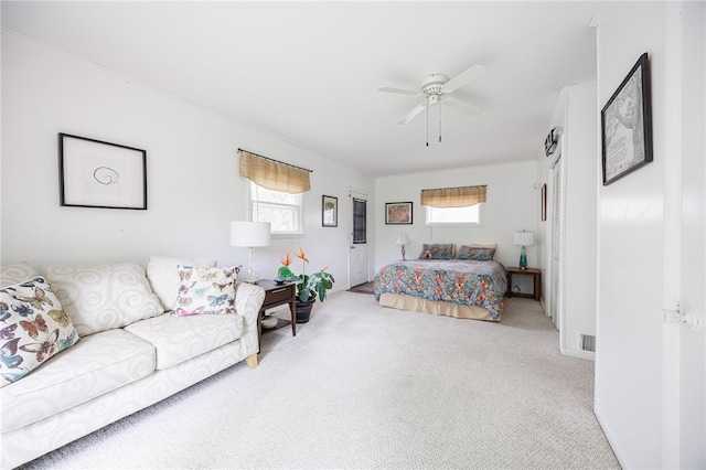 bedroom featuring multiple windows, carpet, and ceiling fan