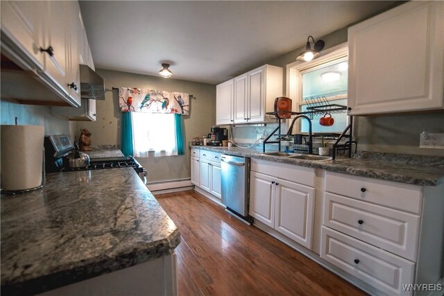 1934 E Middle Rd, Sheridan, NY 14136 - kitchen featuring a sink, appliances with stainless steel finishes, a baseboard radiator, wall chimney exhaust hood, and white cabinetry