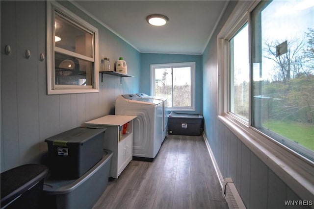 1934 E Middle Rd, Sheridan, NY 14136 - clothes washing area featuring wood finished floors, a baseboard radiator, and ornamental molding