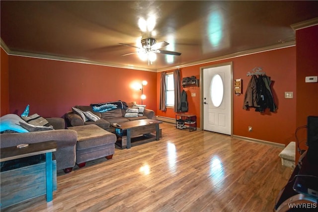 1934 E Middle Rd, Sheridan, NY 14136 - living area featuring baseboard heating, crown molding, ceiling fan, wood finished floors, and baseboards