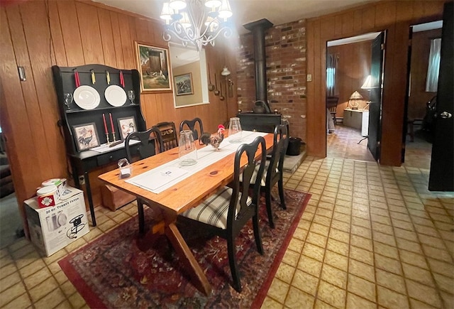920 New Kingston Rd, Middletown, NY 12455 - dining area with wooden walls, a chandelier, and a wood stove
