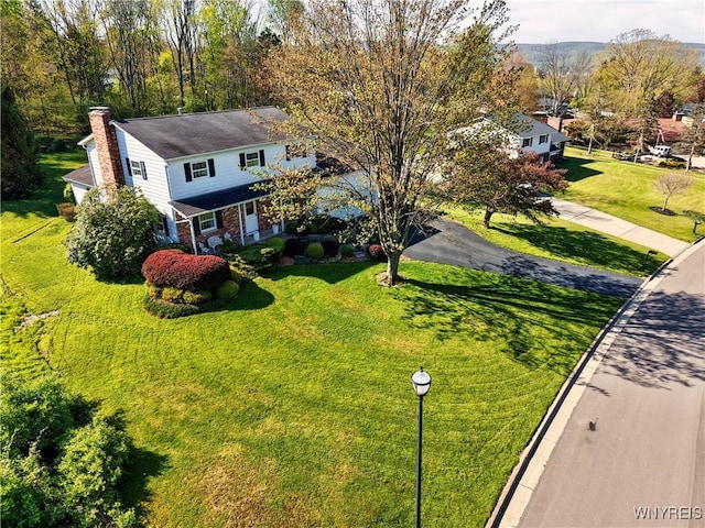 1604 Stardust Ln, Olean-City, NY 14760 - view of front of house with a chimney, covered porch, driveway, a front yard, and brick siding