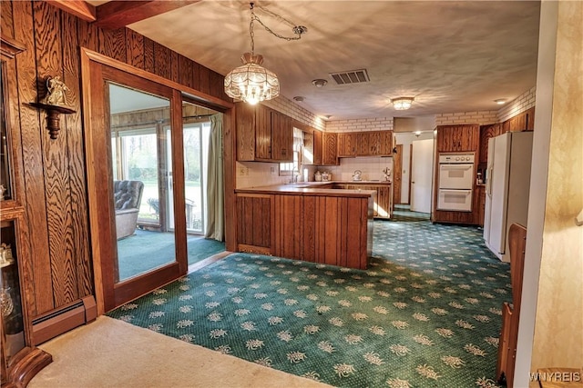 1604 Stardust Ln, Olean-City, NY 14760 - kitchen featuring baseboard heating, brown cabinets, dark carpet, and white appliances