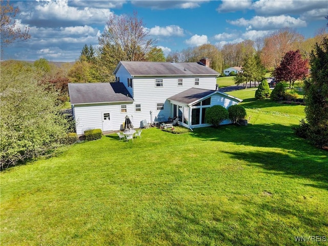 1604 Stardust Ln, Olean-City, NY 14760 - back of property featuring a sunroom, a yard, and a chimney