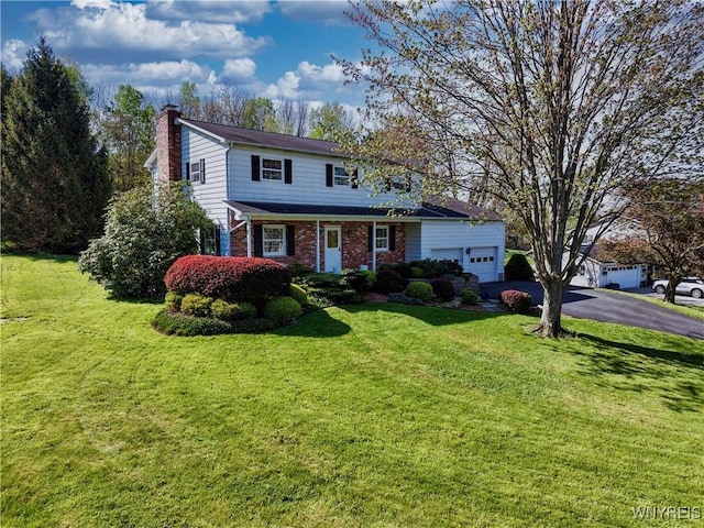 1604 Stardust Ln, Olean-City, NY 14760 - traditional-style home featuring a chimney, asphalt driveway, brick siding, a front lawn, and a garage