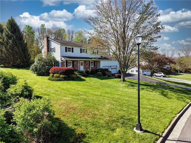 1604 Stardust Ln, Olean-City, NY 14760 - traditional-style house featuring a chimney, driveway, brick siding, a front yard, and an attached garage