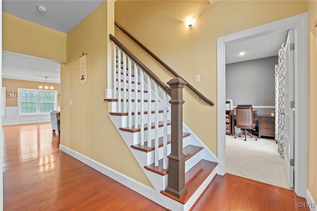 3543 Lost Hollow Rd, Skaneateles, NY 13152 - staircase featuring wood finished floors and a chandelier