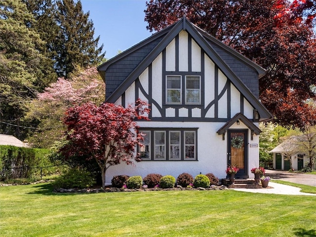 tudor house featuring stucco siding