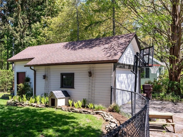view of outdoor structure with an outbuilding, a garage, and driveway