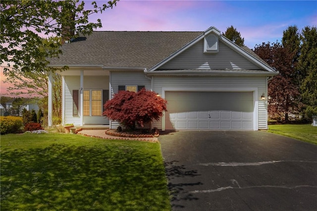 view of front of property with driveway, an attached garage, a front yard, and roof with shingles