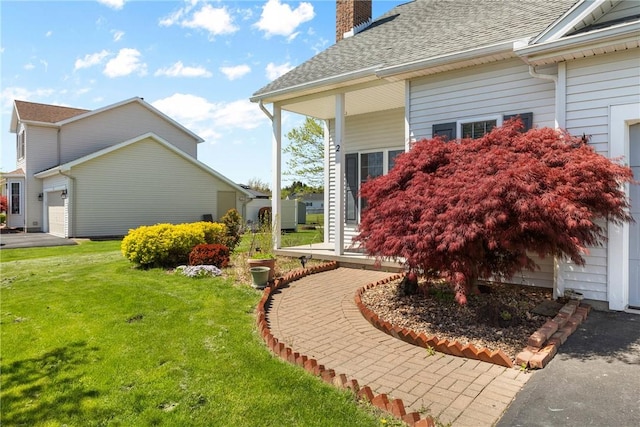 view of property exterior with a chimney, a lawn, an attached garage, and a shingled roof
