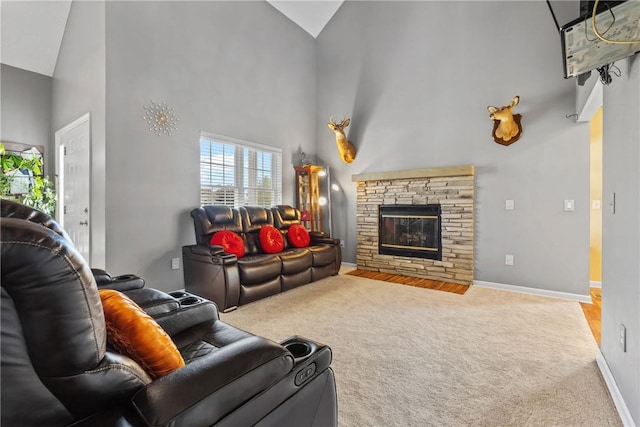 carpeted living room featuring high vaulted ceiling, baseboards, and a stone fireplace