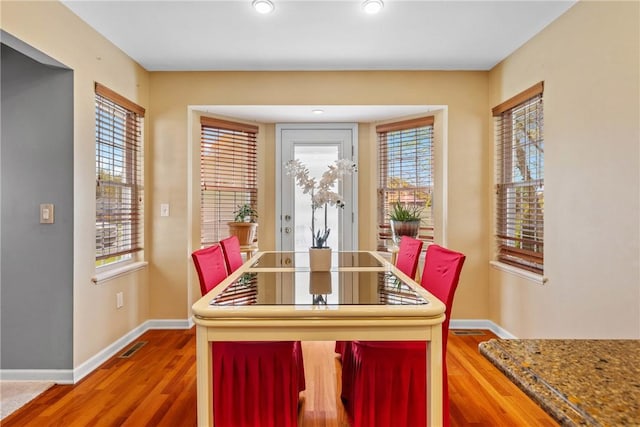 dining area featuring baseboards and wood finished floors