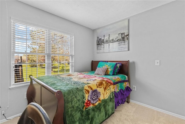 carpeted bedroom with baseboards and a textured ceiling