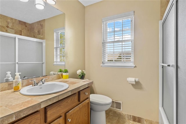full bathroom featuring an enclosed shower, toilet, vanity, tile patterned flooring, and baseboards
