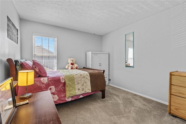 carpeted bedroom with a textured ceiling and baseboards