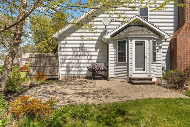 rear view of property with a patio and fence