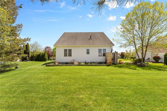 back of house with a lawn