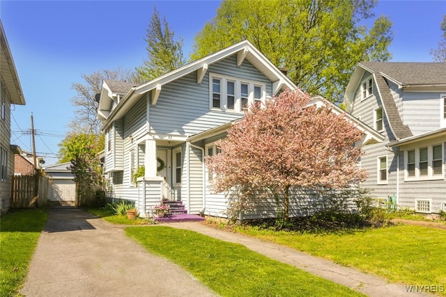 82 Radcliffe Rd, Buffalo, NY 14214 - view of front facade featuring a front lawn, a detached garage, and an outbuilding